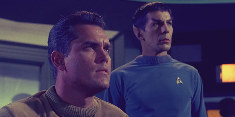 Captain Pike and Mr. Spock look on in The Cage