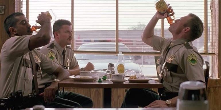 Three troopers drinking maple syrup from the bottle in Super Troopers.