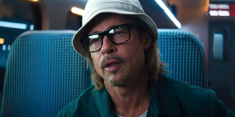 Brad Pitt wearing a hat and glasses as Ladybug in Bullet Train