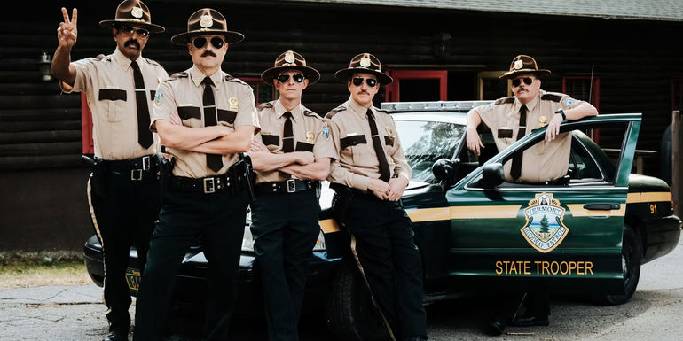 The state troopers leaning against their car and one givnig a peace sign in Super Troopers.