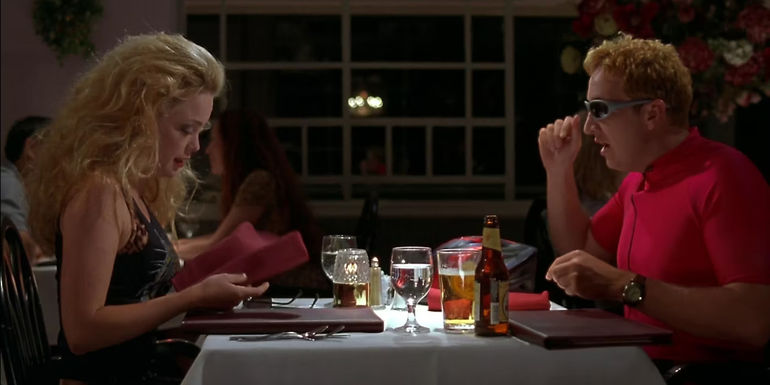 Ursula (Marisa Coughlan) dressed as a biker chick and Foster (Paul Soter) dressed as a bicyclist having dinner in Super Troopers.