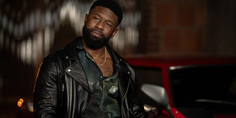 Trevante Rhodes leaning against car in Mea Culpa