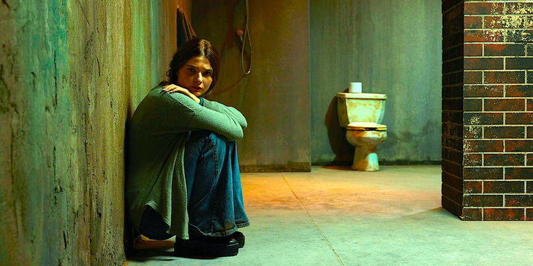 Stefanie Scott sitting on the floor in Lifetime's Girl in the Basement