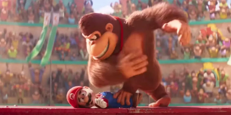 Mario being held down by Donkey Kong in a stadium showdown in The Super Mario Bros.