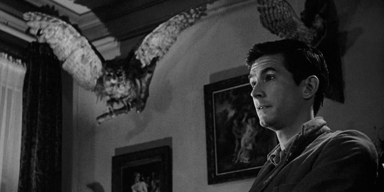 Anthony Perkins as Norman Bates with his taxidermy behind him in Psycho.