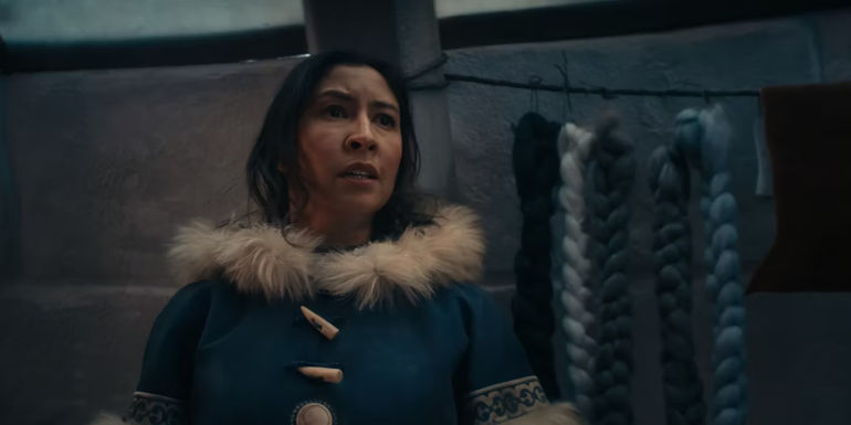 Kya looking in fear at a Firebender in Netflix's Avatar: The Last Airbender