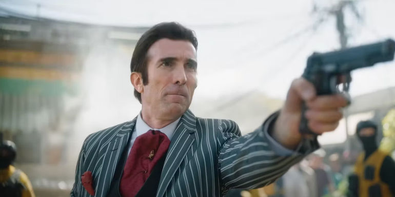 Sharlto Copley holding a pistol in Boy Kills World