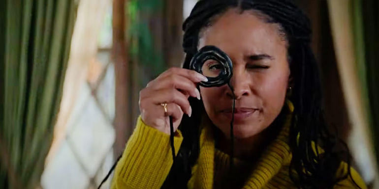 Helen Grace looking through a holed stone in The Spiderwick Chronicles series