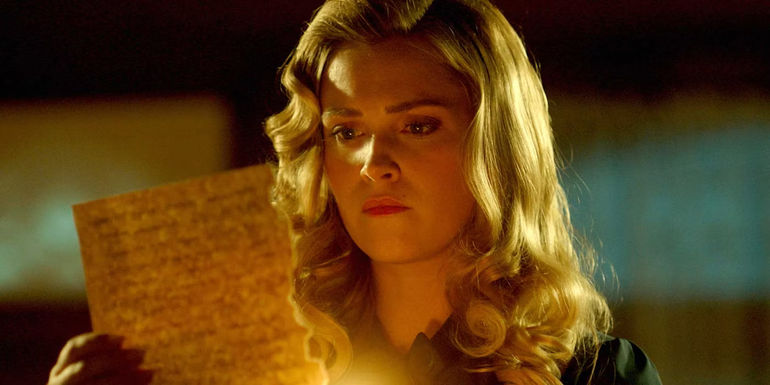 Eliza Taylor as Hannah burning a paper in Quantum Leap season 2 - A Glimpse into the Future