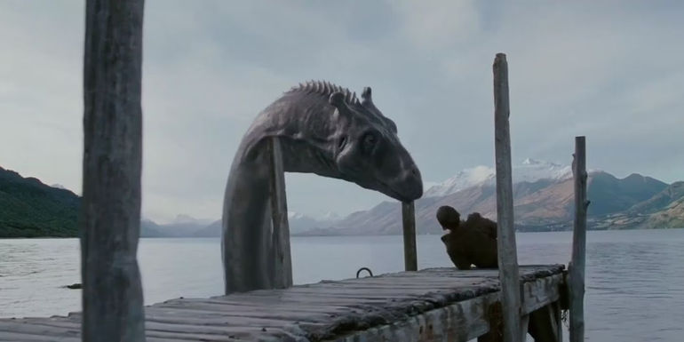 Crusoe looking at a mysterious person laying on the dock in The Water Horse: Legend of the Deep - The Water Horse: Legend Of The Deep (2007)