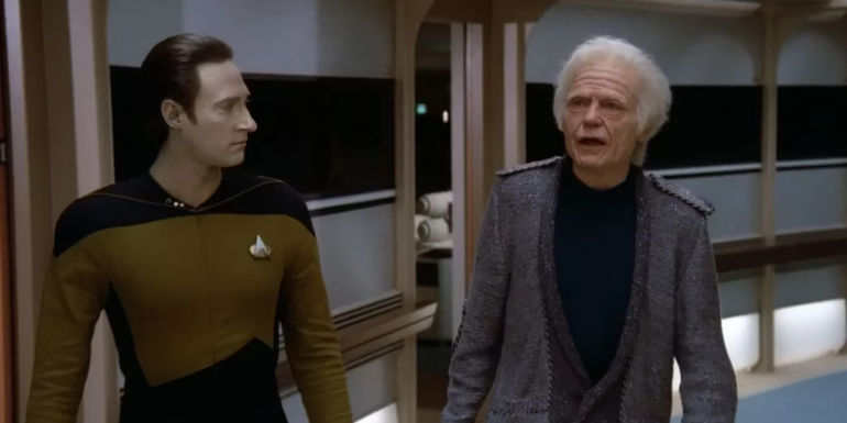 Doctor McCoy and Data walk down the hall in Star Trek TNG