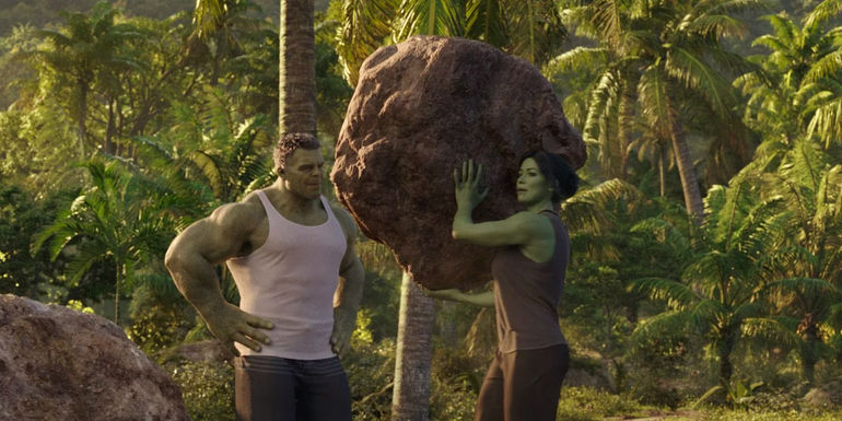 She-Hulk lifting a rock as she talks with Hulk amid their training