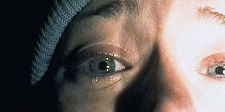 A woman cries while holding a camera from Blair Witch Project