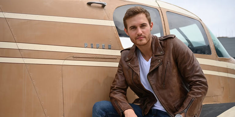 The Bachelor's Peter Weber Crouching in Front of a Plane