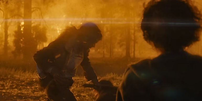 Hannah (Angelina Jolie) strikes Patrick (Nicholas Hoult) with an ax while Connor (Finn Little) watches in Those Who Wish Me Dead