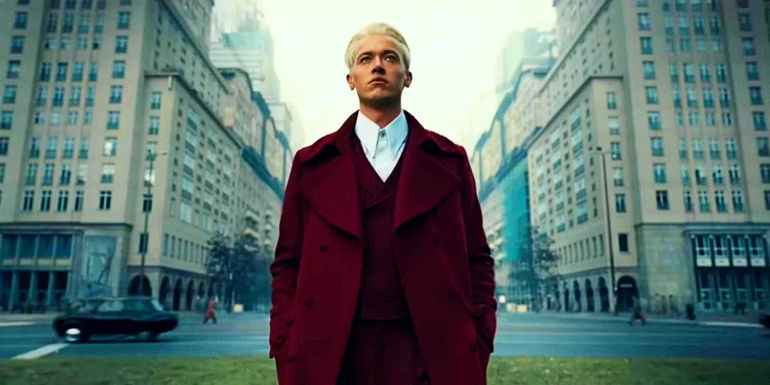 Tom Blyth as Coriolanus Snow is standing in the Capitol in The Hunger Games Ballad of Songbirds and Snakes