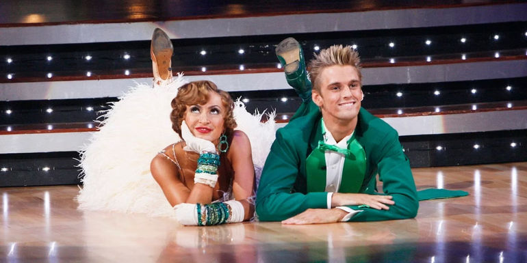 Karina Smirnoff and Aaron Carter lying on the ground and smiling in Dancing With The Stars
