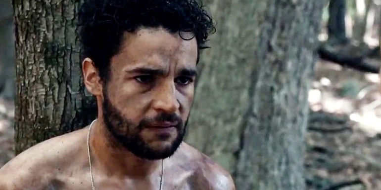 Christopher Abbott leaning against a tree in It Comes At Night