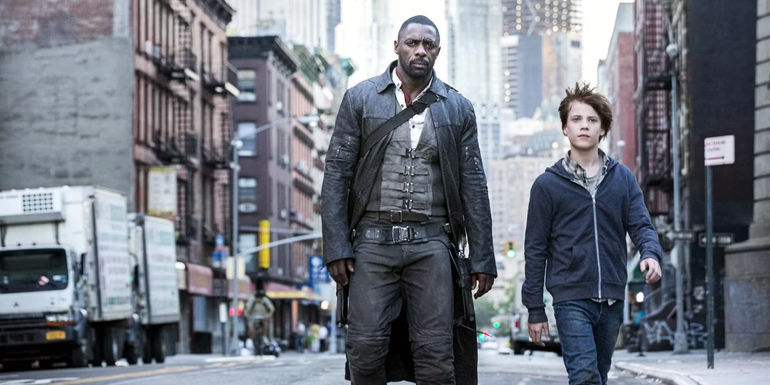 Idris Elba as Roland Deschain and Tom Taylor as Jake Chambers walking through an empty city in The Dark Tower