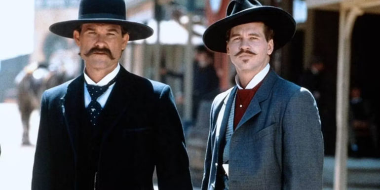 Kurt Russell as Wyatt Earp and Val Kilmer as Doc Holliday assessing a bad situation while standing in the middle of the road in Tombstone