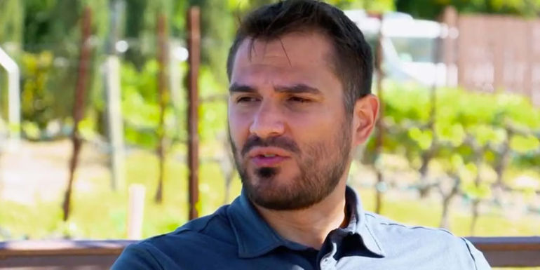 Miguel Santiago MAFS posing outdoors in blue dress shirt