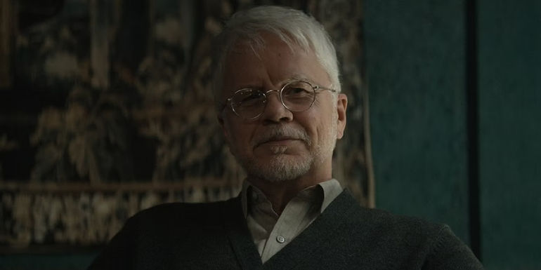 Tim Robbins' Bernard smiling in Silo