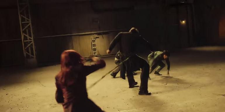 Kurama holding Toguro while Huei and Yusuke attack him