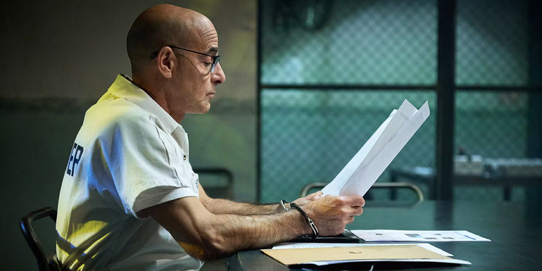 Stanley Tucci reading documents in Inside Man