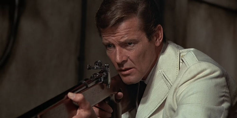 Roger Moore with a rifle in The Man with the Golden Gun