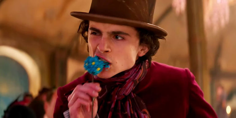Timothee Chalamet as Willy Chomping on a Flowery Candy in Wonka