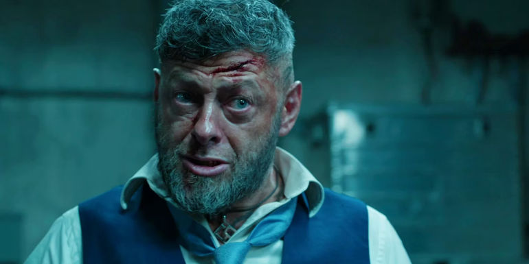 A bloody Andy Serkis talks to an off-screen character as Ulysses Klaue in Black Panther.