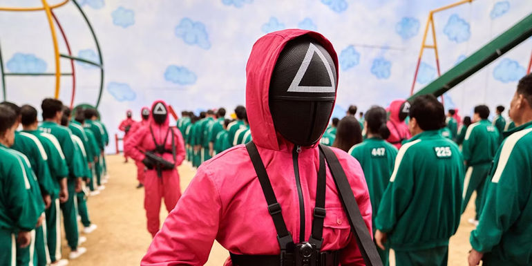 The Red Guard walking between rows of contestants in Squid Game