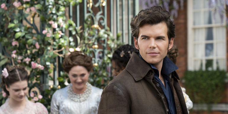 Luke Newton's Colin smiling with a dashing look in Bridgerton season 3