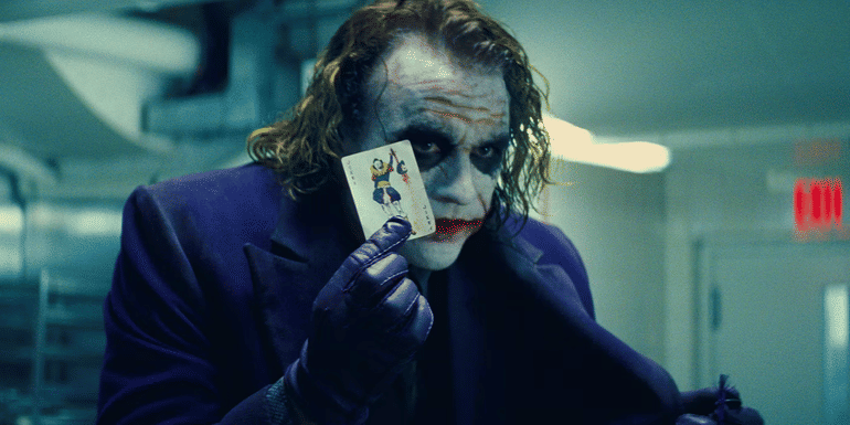 The Joker (Heath Ledger) holding a joker playing card in The Dark Knight