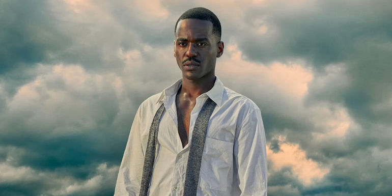 The Fifteenth Doctor (Ncuti Gatwa) with clouds behind him and his tie undone in Doctor Who.