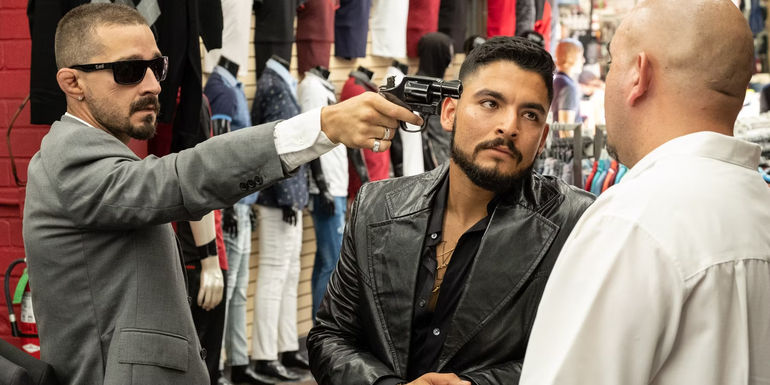 Shia LaBeouf and Bobby Soto pointing a gun at a man in The Tax Collector