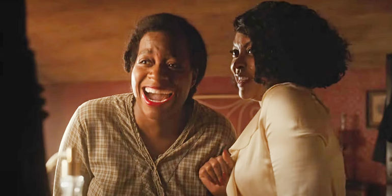 Celie smiling next Shug Avery in The Color Purple