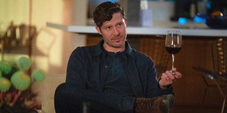 Elias Voit holding a wine glass in Criminal Minds: Evolution