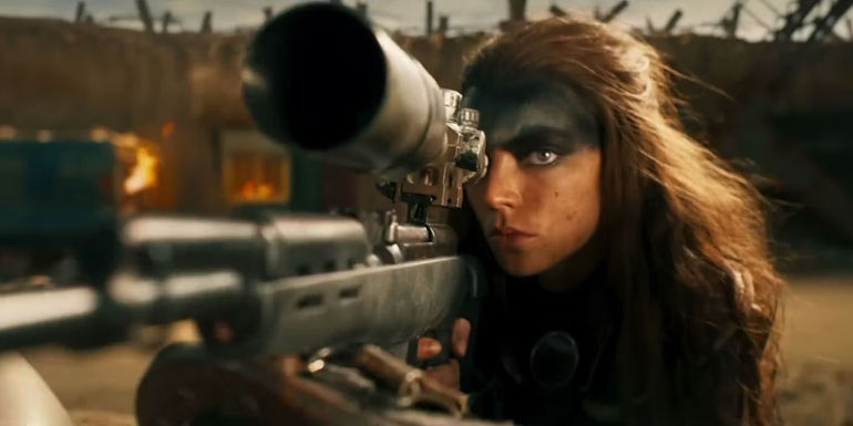 Furiosa aims down her sniper rifle's scope in the heat of battle in Furiosa