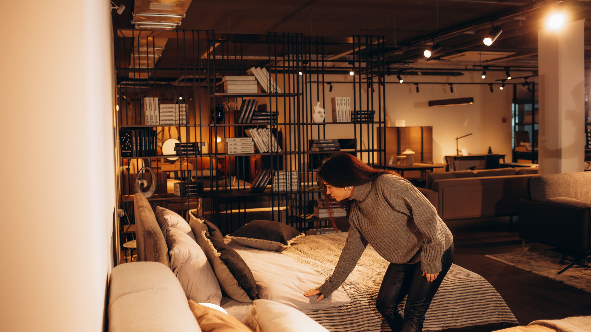 Happy woman smiling while looking to buy a new bedroom furniture at the showroom 