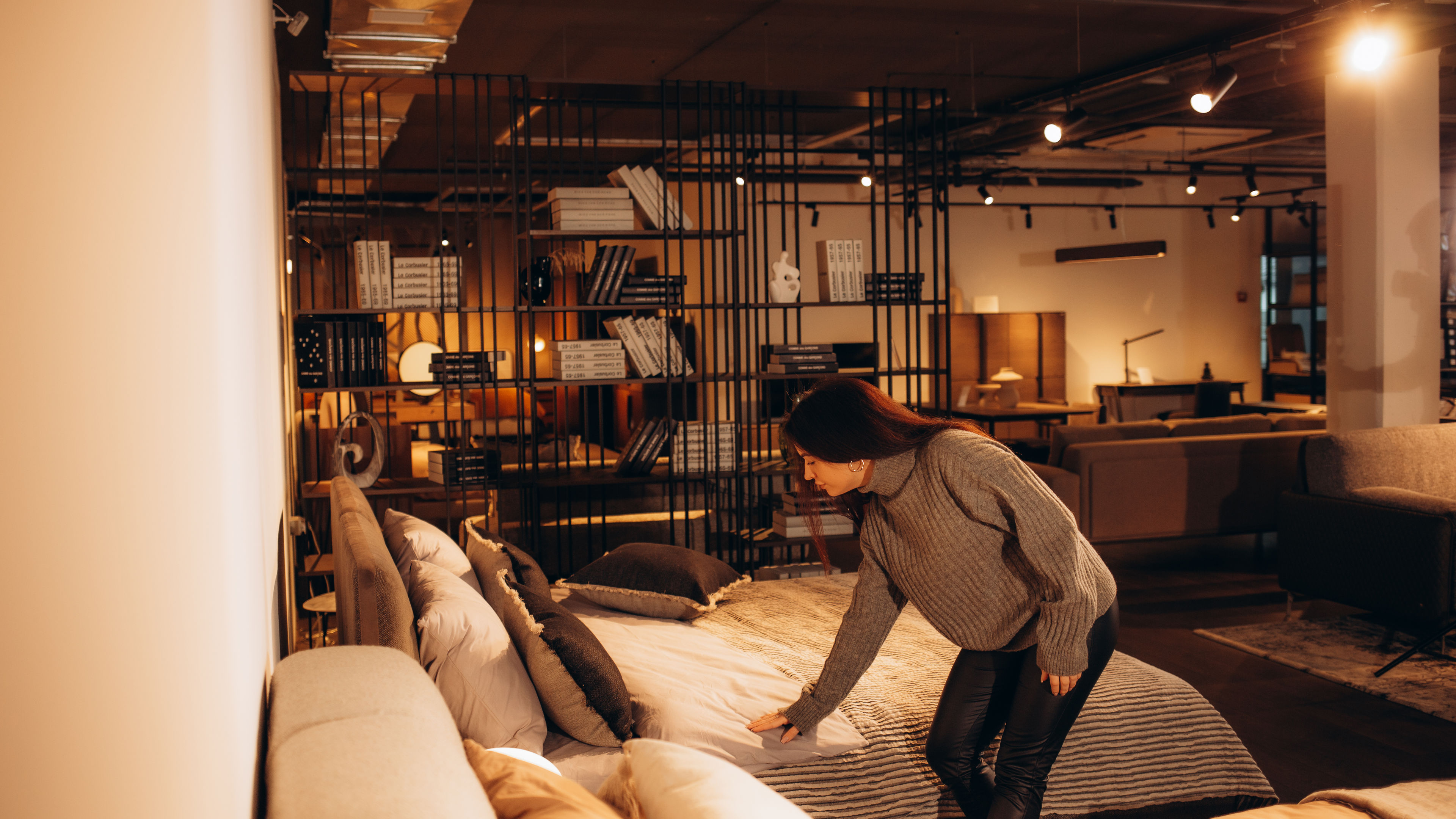 Happy woman smiling while looking to buy a new bedroom furniture at the showroom