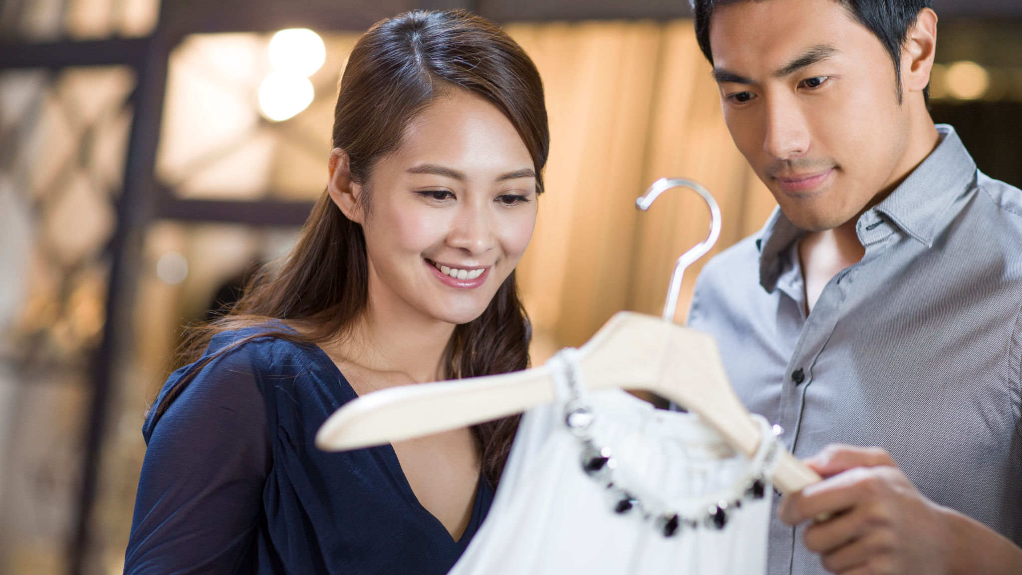 A man and a woman choosing clothes