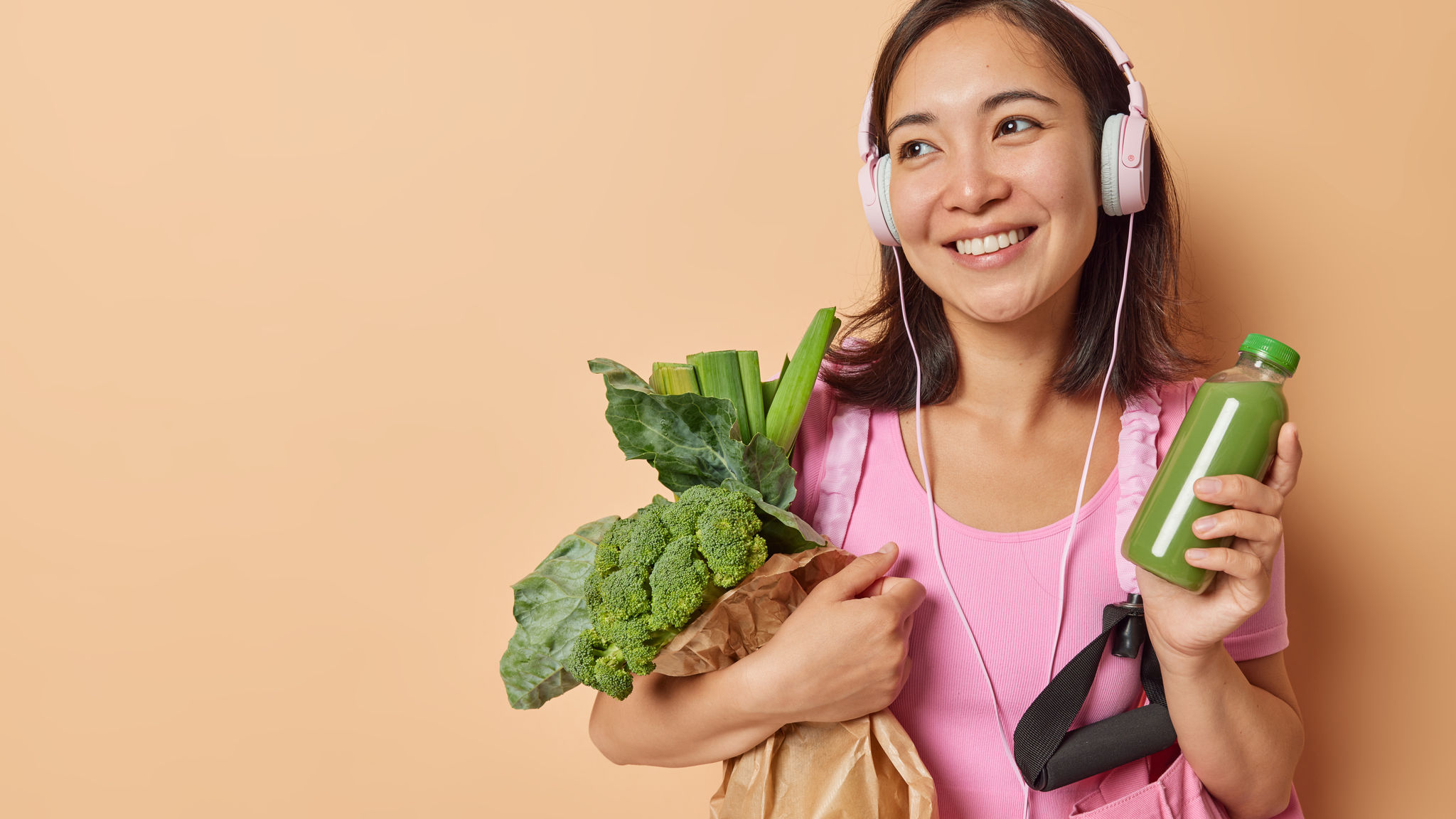 A woman with a veggie bag in hand 