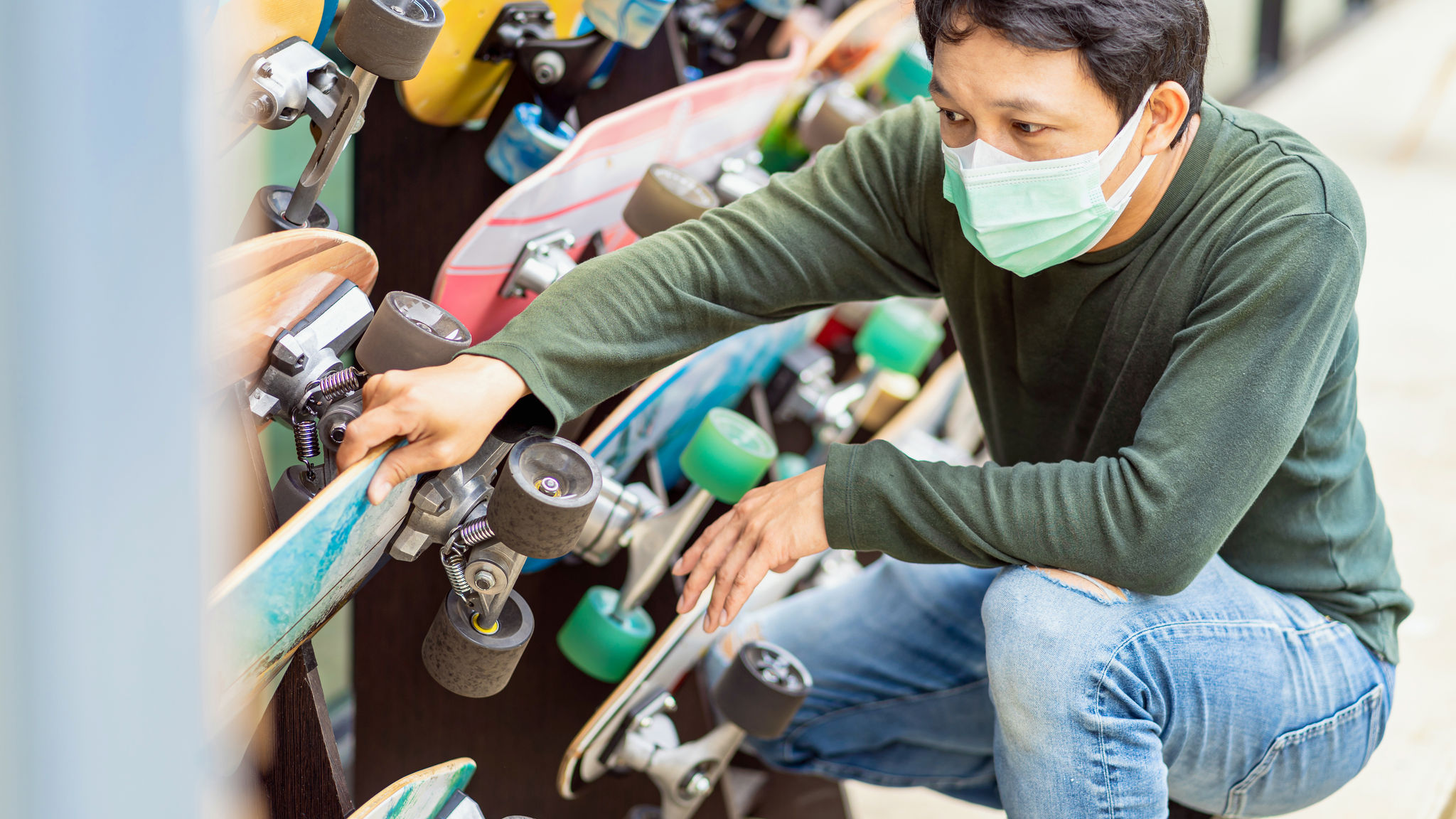 Asian Cheerful man choosing surfskate for testing and skating in front of the surfskate planet x 