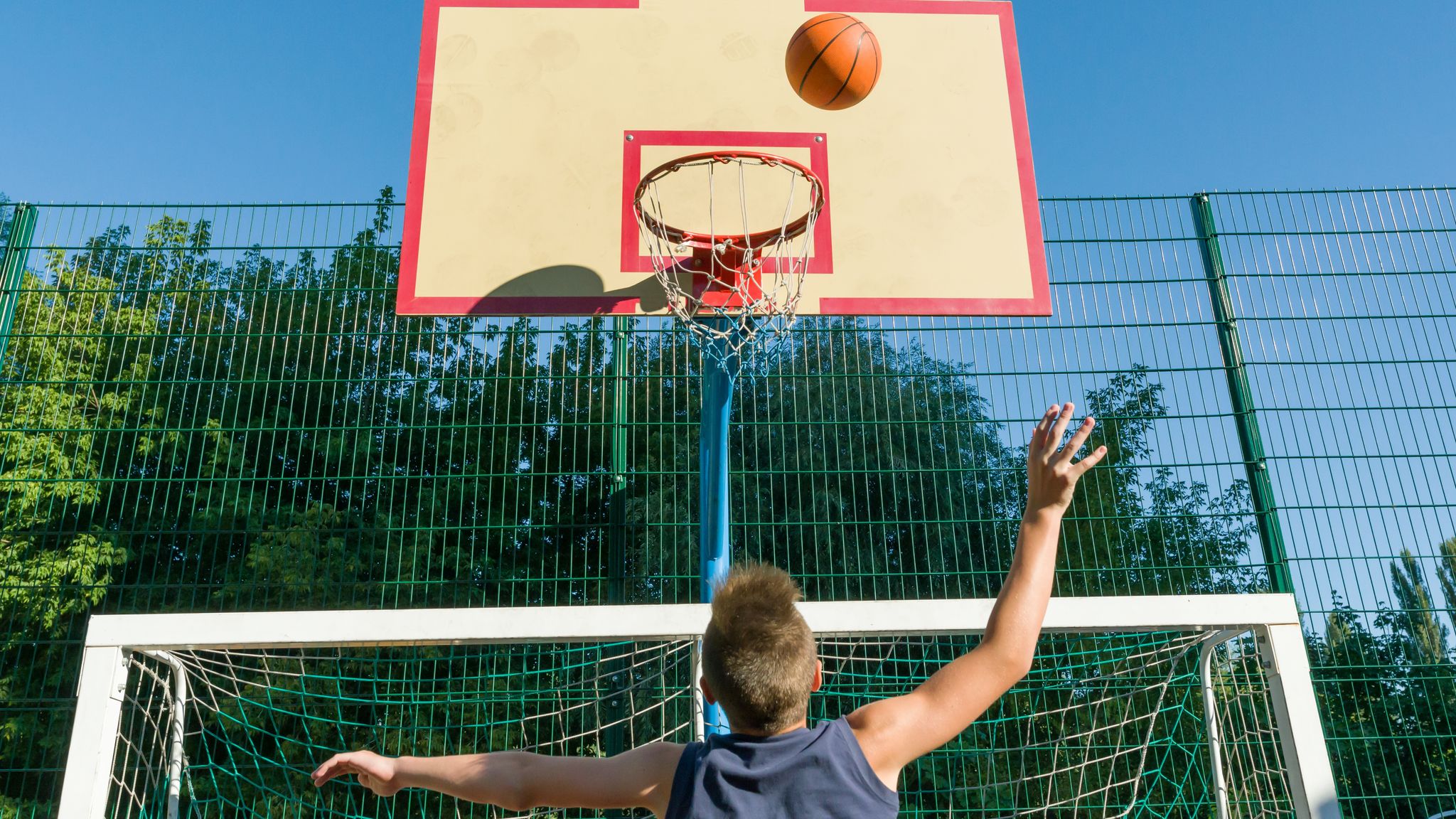 Teenager boy street basketball player sa city basketball court 