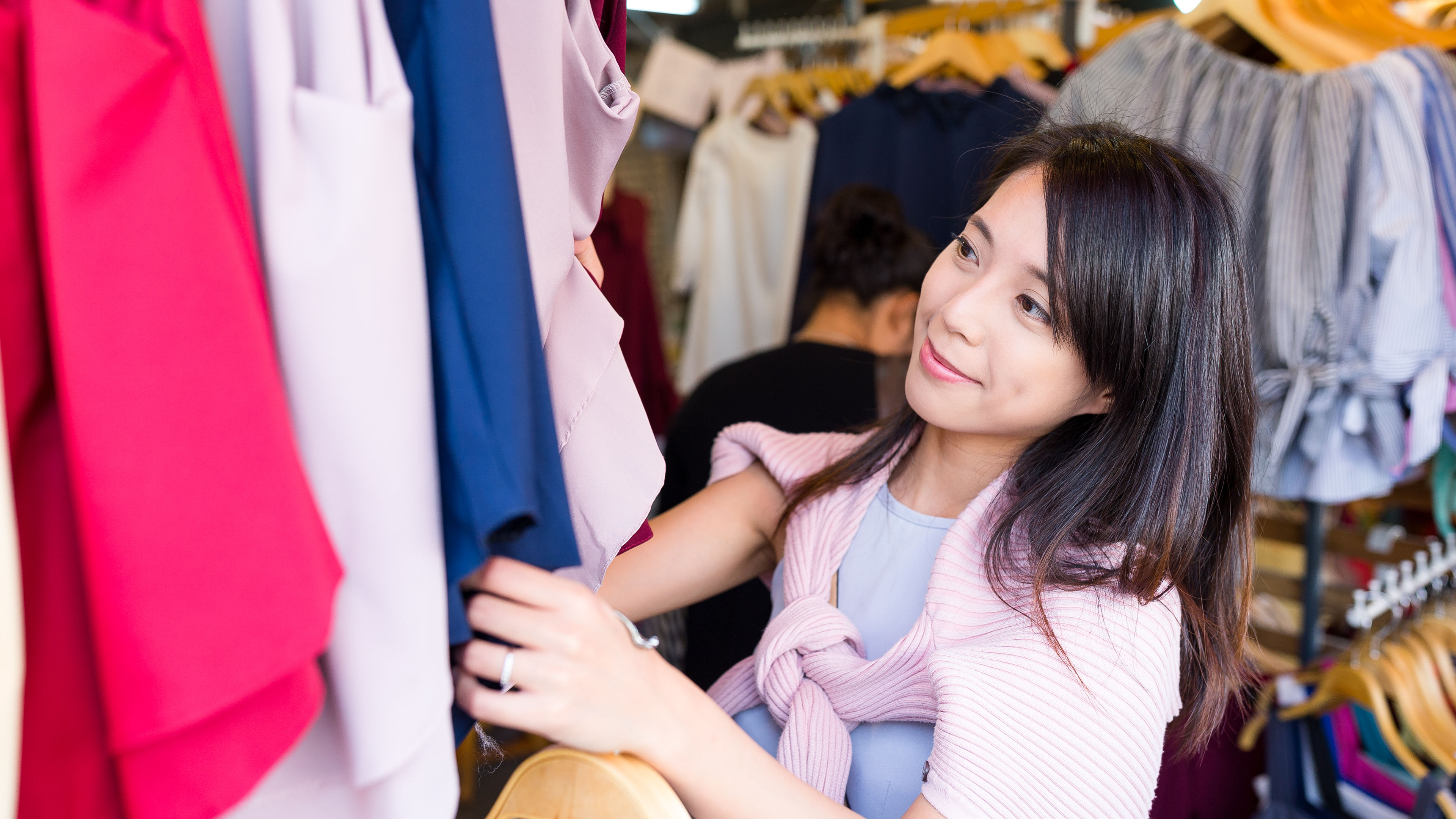 A woman selecting clothes in a store 