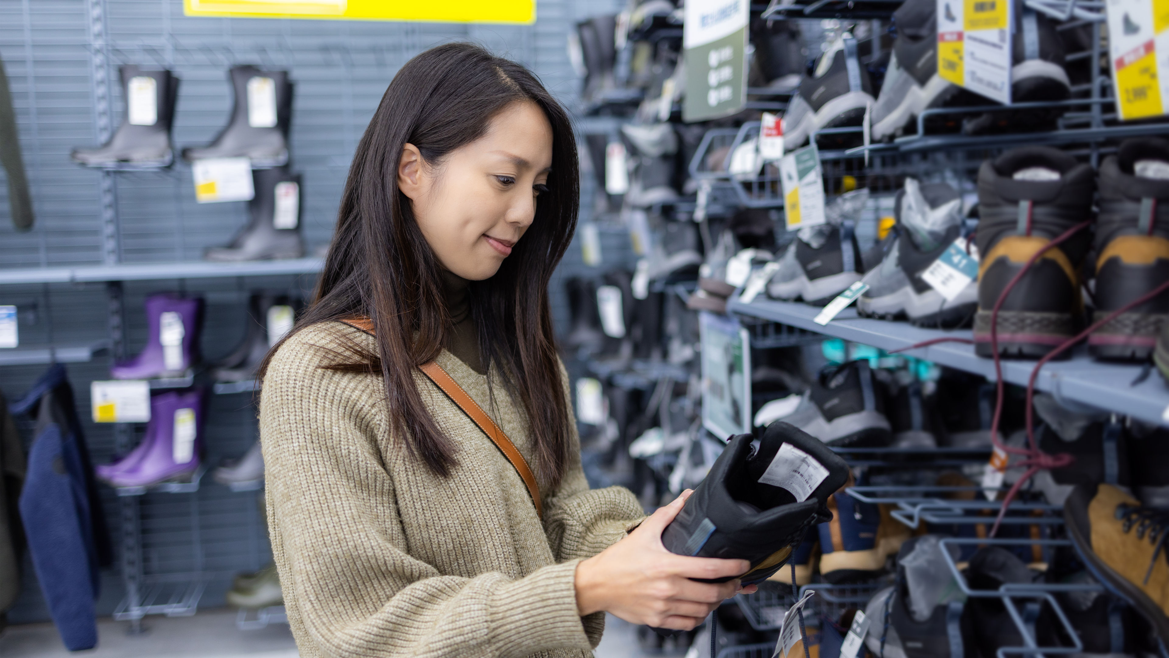 A woman looking at shoes in a shop