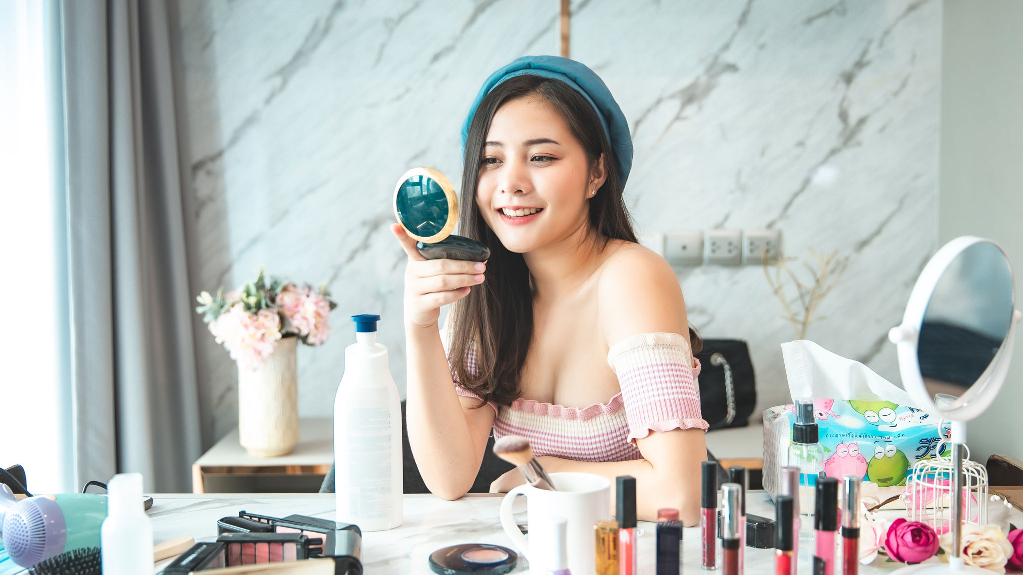 Portrait of young asian woman review cosmetics prosduct 