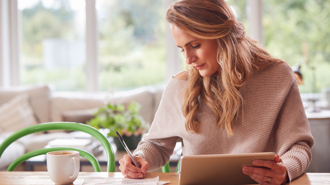 woman-with-digital-tablet-sitting-at-table-at-home-2021-08-30-19-59-21-utc