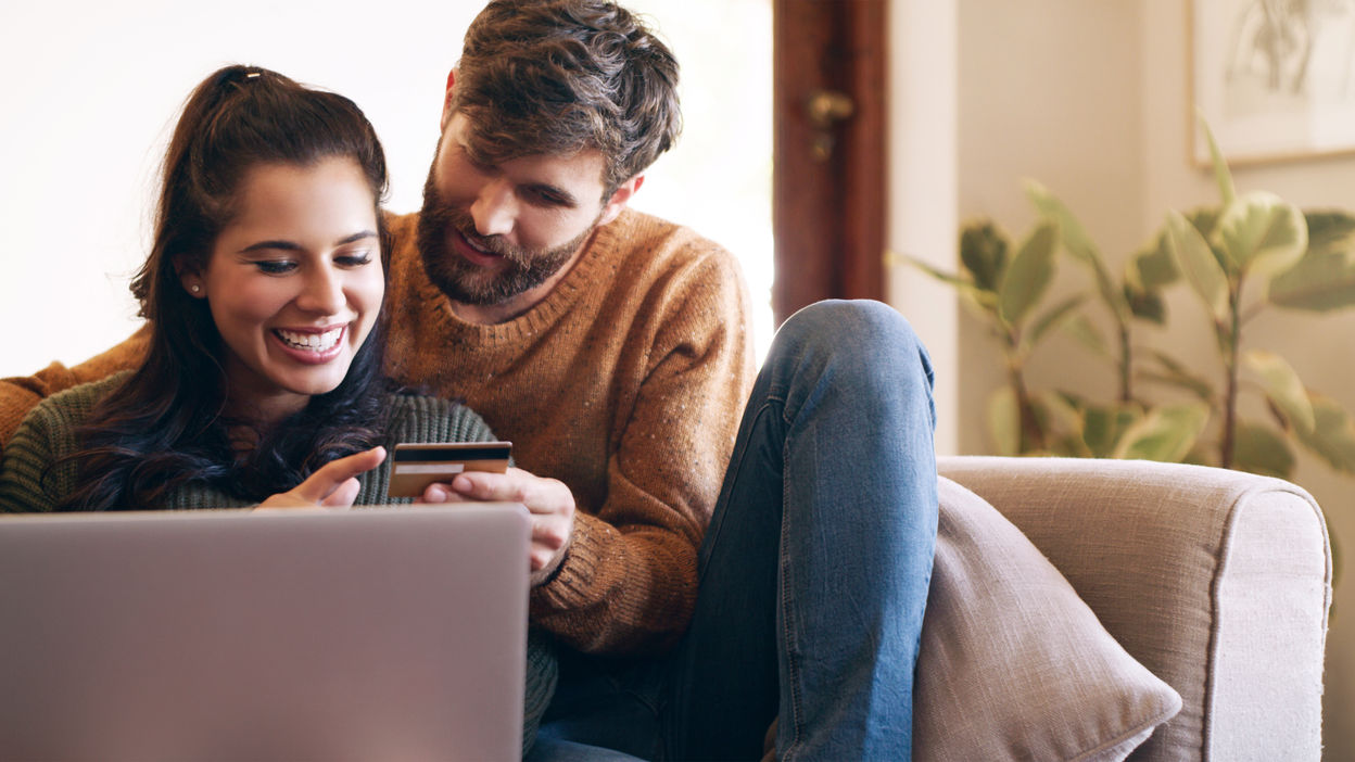 shot-of-a-young-couple-using-a-laptop-and-credit-c-2022-10-06-02-02-28-utc